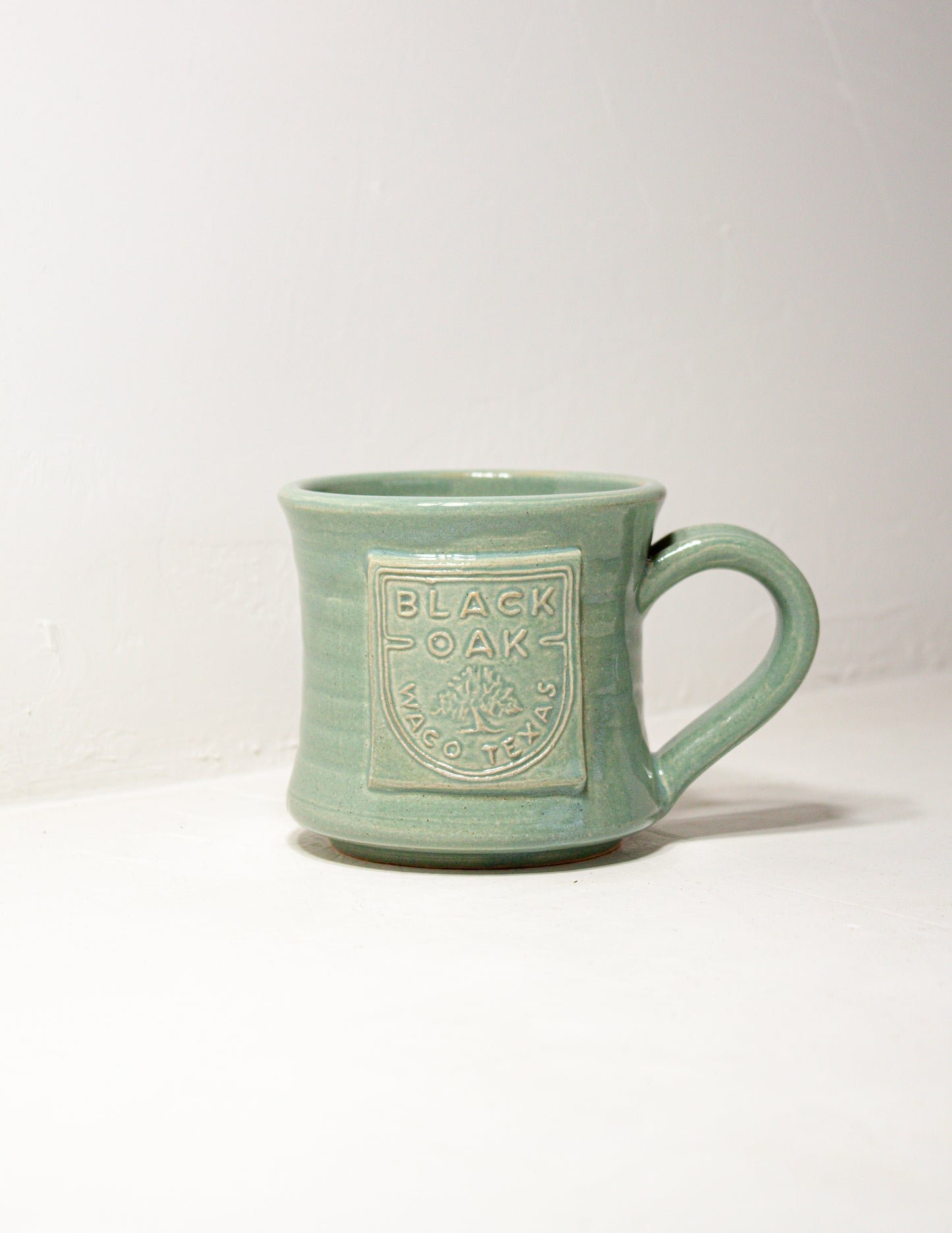 Hand thrown mug in standard shape with robin's egg glaze