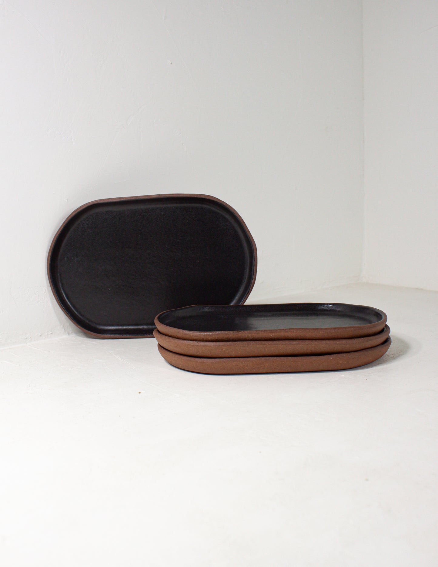 handmade serving dish in the shape of a small oval in black glaze