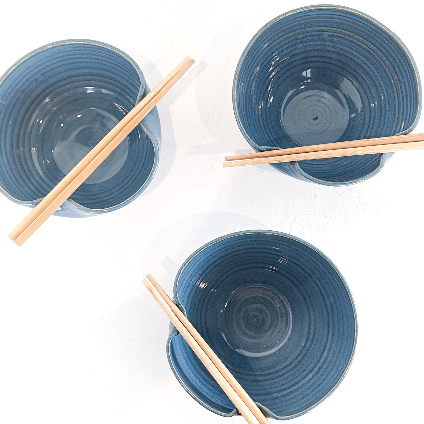 Handmade ceramic bowl featuring a folded lip for a convenient utensil holder. These Handmade bowls are made by Black Oak Art in Waco, Texas.