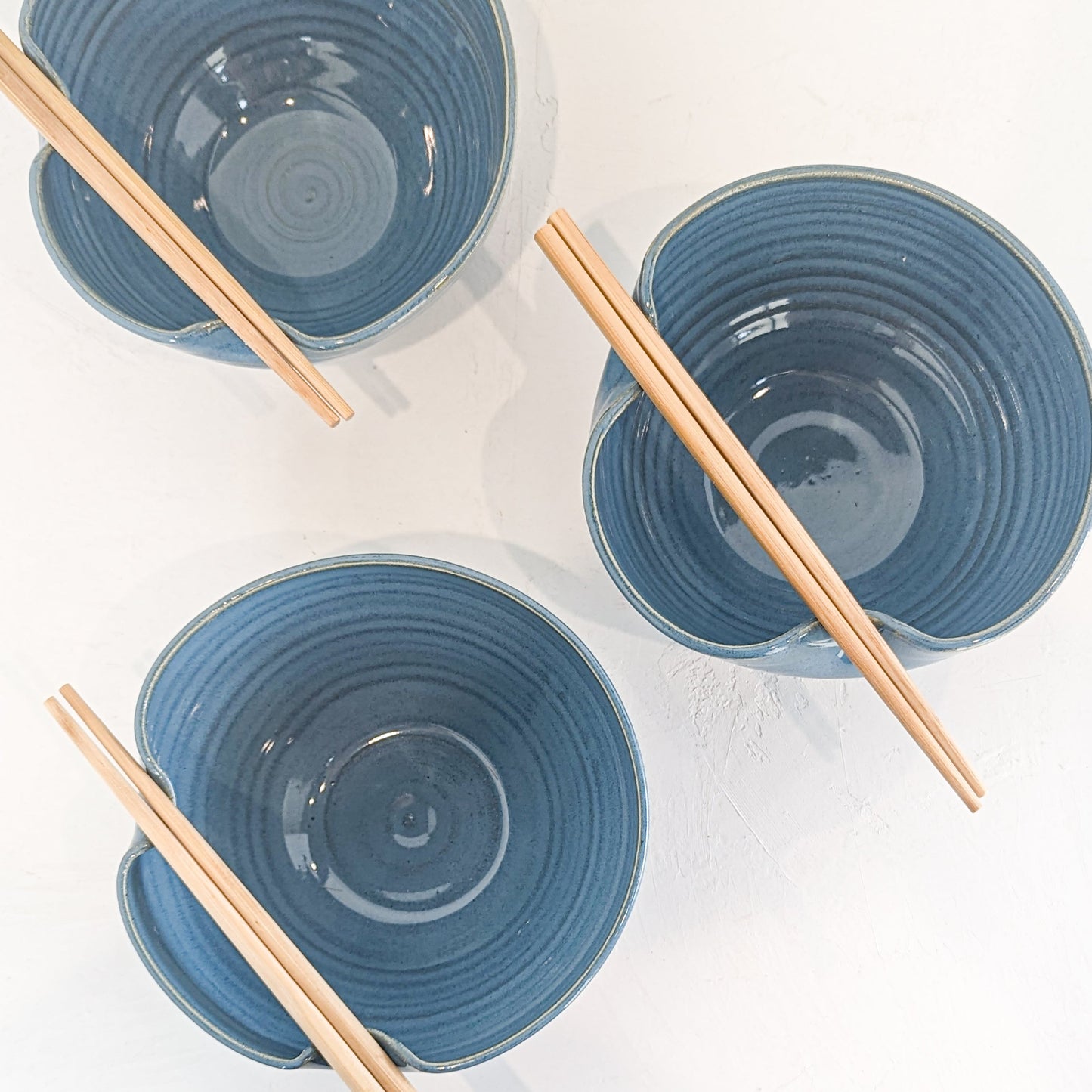 Handmade ceramic ramen bowl featuring a folded lip for a convenient utensil holder. These Handmade bowls are made by Black Oak Art in Waco, Texas.