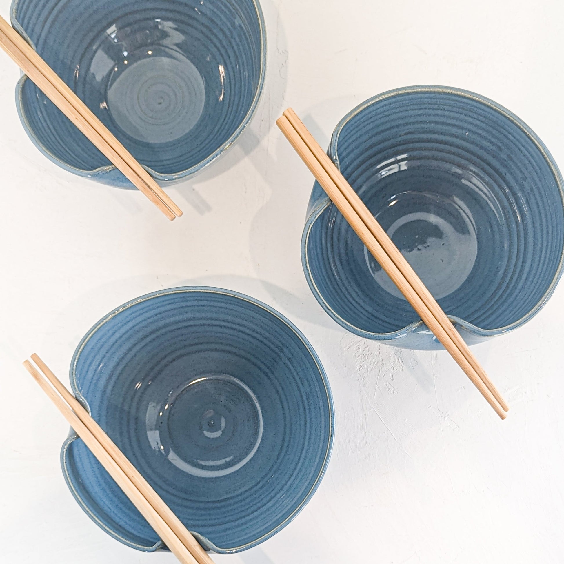 Handmade ceramic ramen bowl featuring a folded lip for a convenient utensil holder. These Handmade bowls are made by Black Oak Art in Waco, Texas.