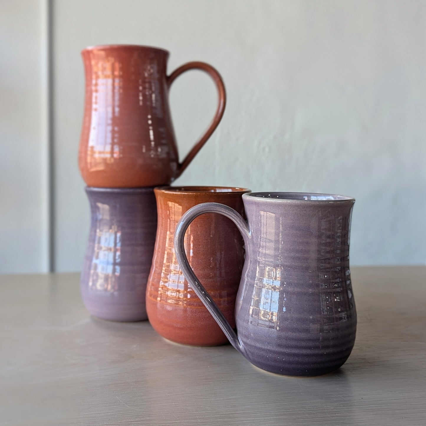 tall potbelly hand thrown handmade mugs orange and purple