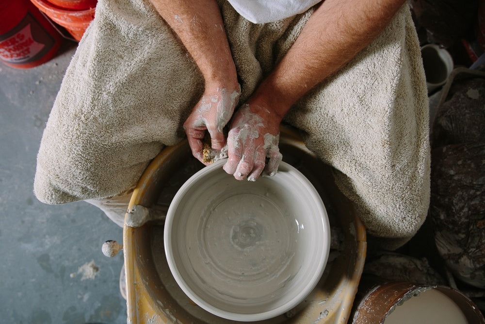 Artisan making hand thrown pottery at Black Oak Art, a premier handcrafted pottery supplier