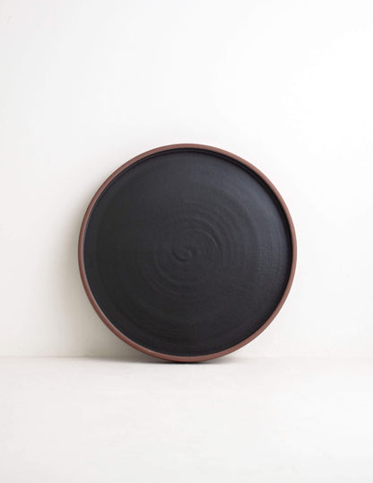 Earthy dark clay ceramic straight dinner plate in Waco, TX