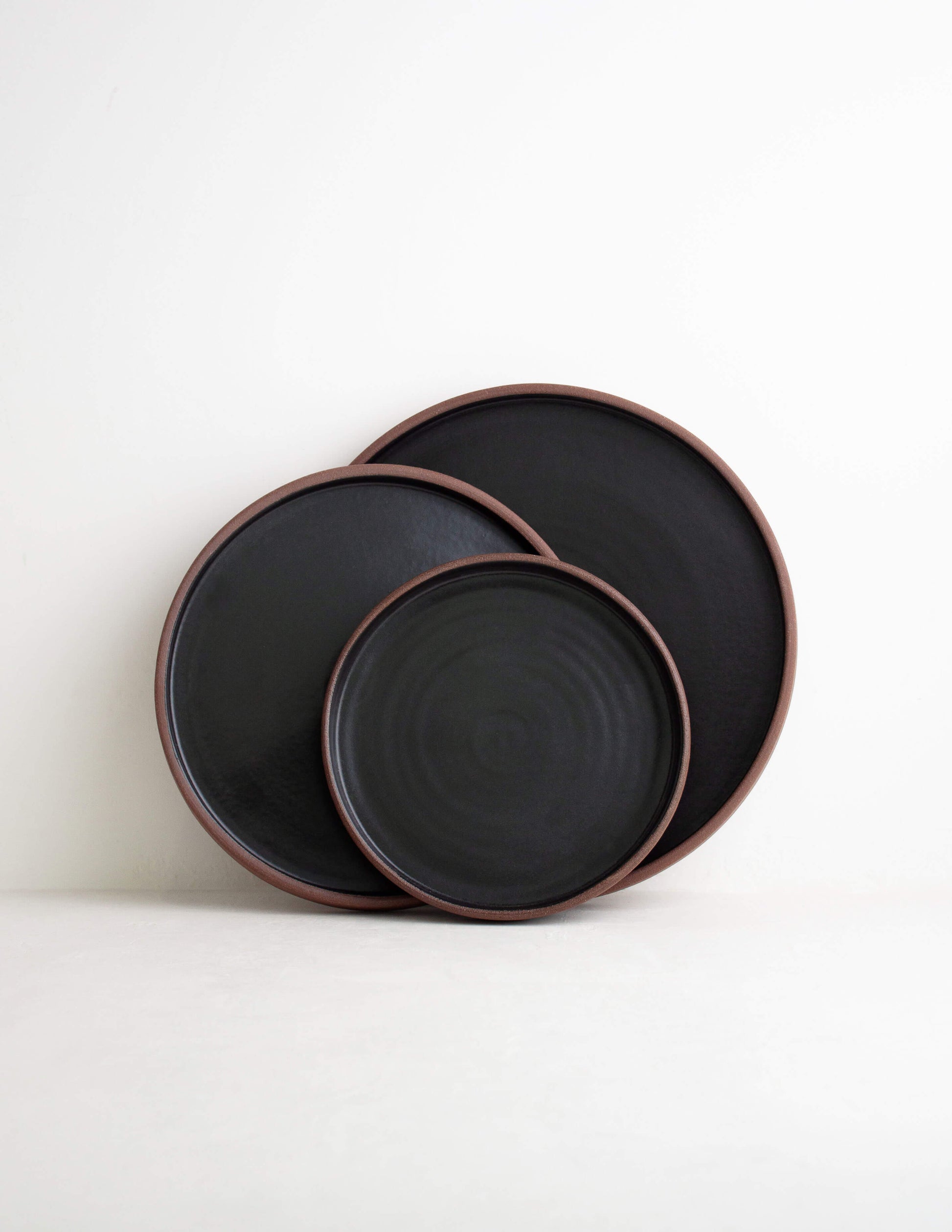 Kiln-fired dark clay straight side dinner plate in Waco, TX