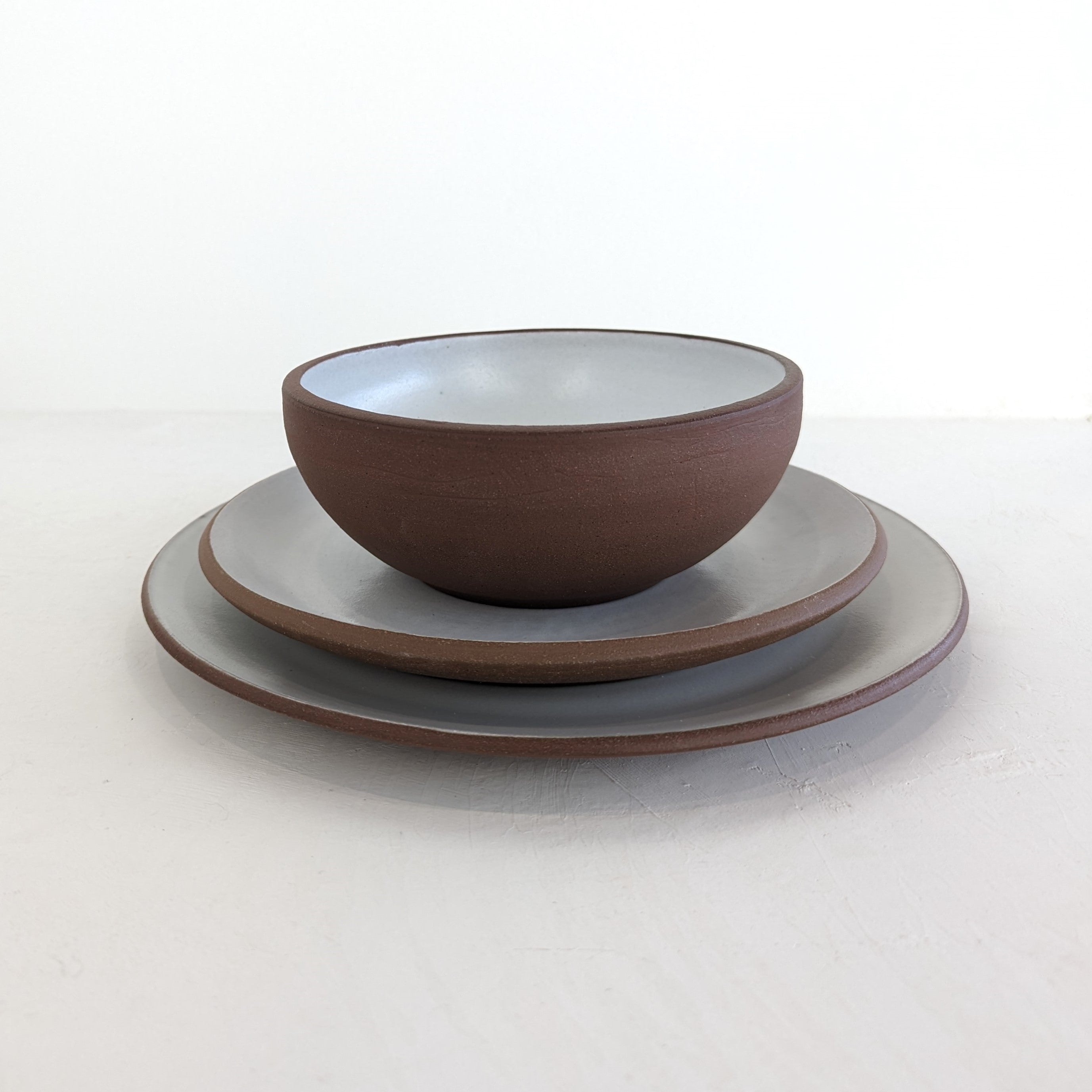 Handmade ceramic plate setting made by Black Oak Art, who specializes in handmade ceramics