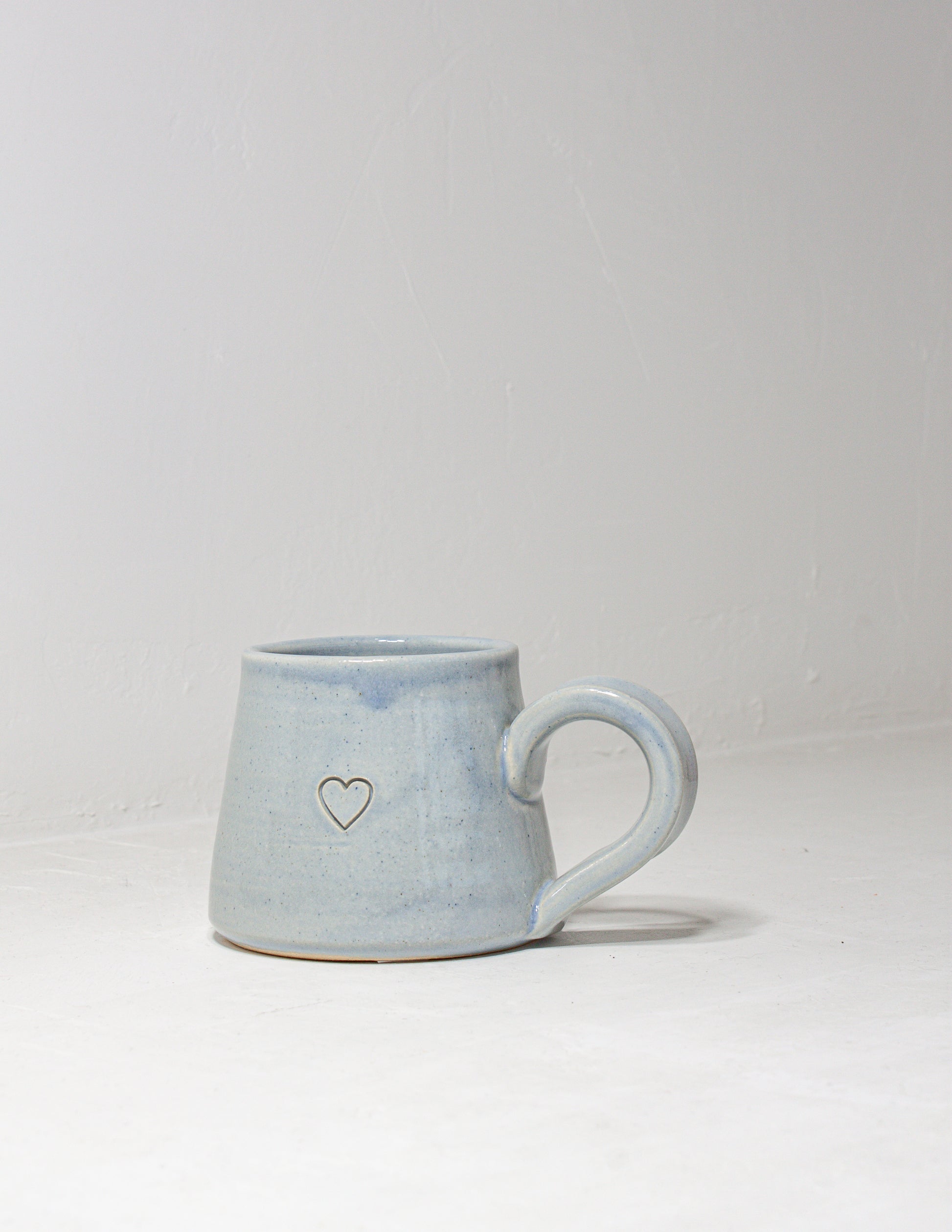 Handmade mug featuring an indented heart that is perfect for Valentine's day
