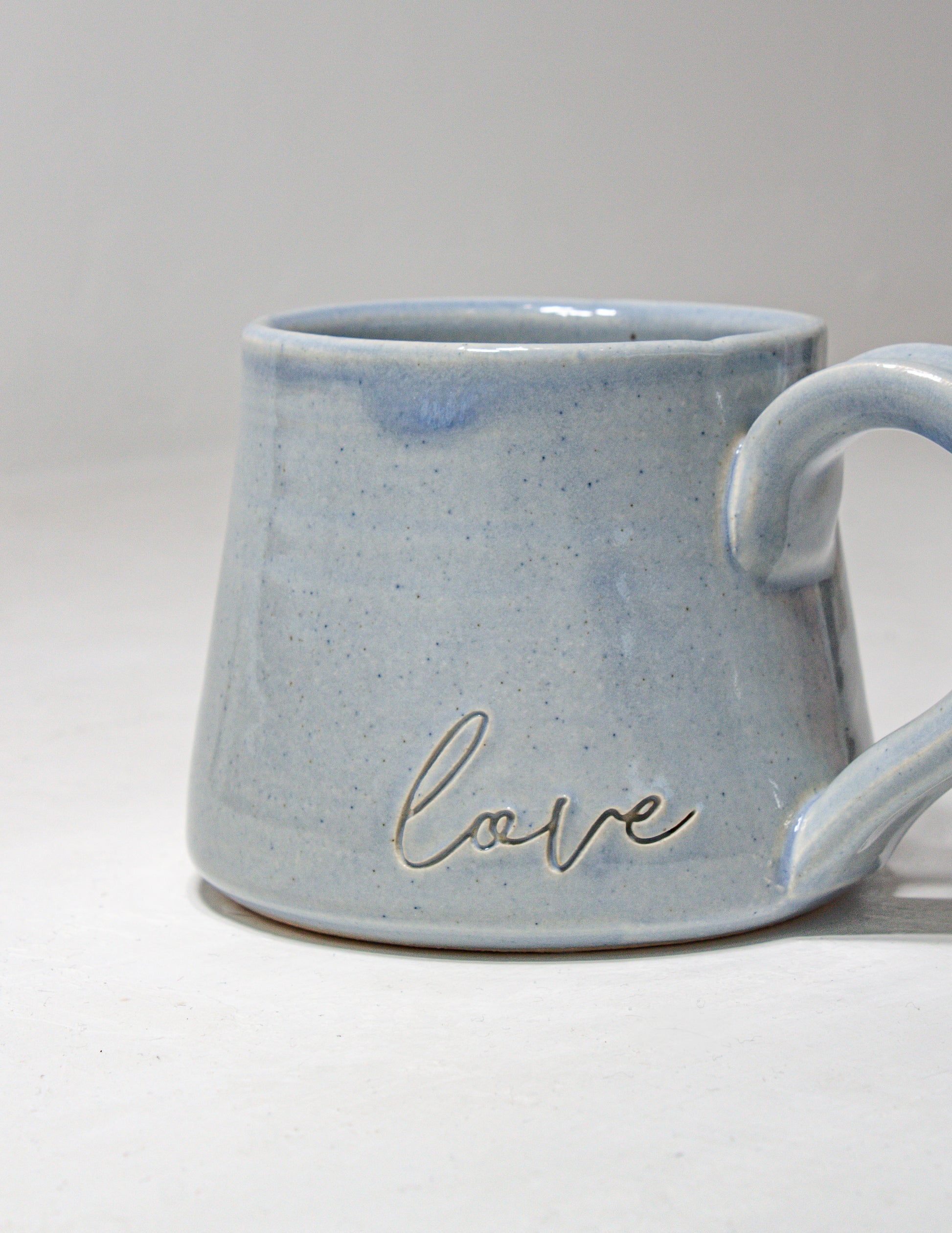 handmade ceramic mug with an inscription of love
