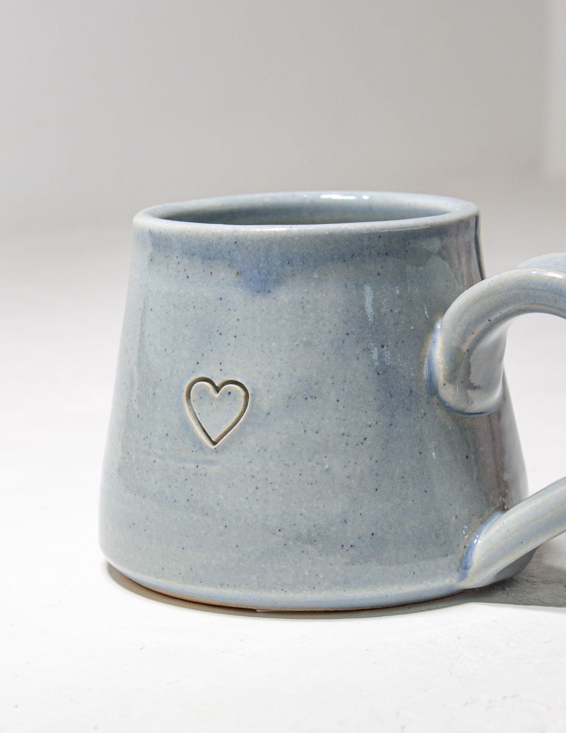 Handmade mug featuring an indented heart that is perfect for Valentine's day