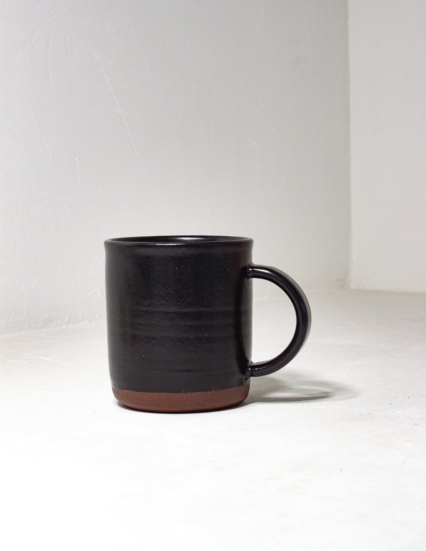 Hand thrown mug dipped in a black glaze