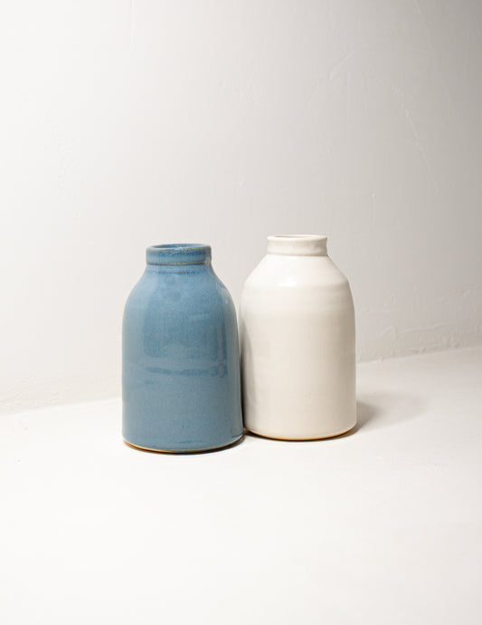 two hand thrown milk bottle vases in blue and white