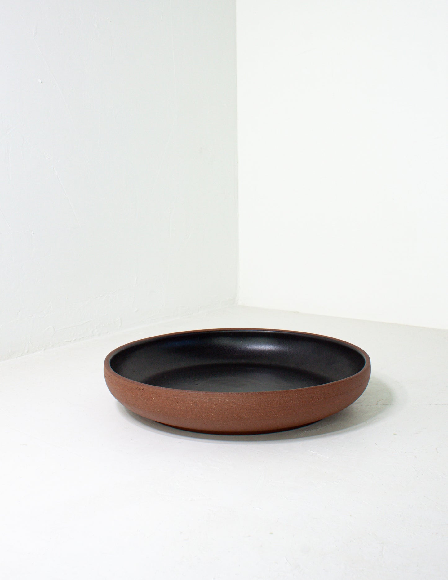 handmade ceramic serving platter in a black glaze