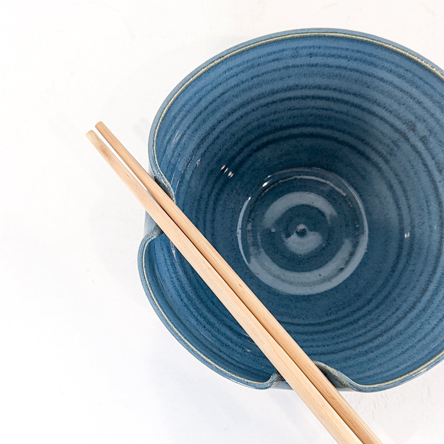 Handmade ceramic bowl featuring a folded lip for a convenient utensil holder. These Handmade bowls are made by Black Oak Art in Waco, Texas.